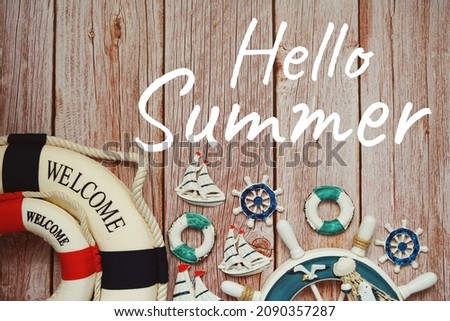 Hello Summer typography text with summer decoration on wooden background