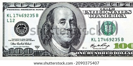 Large fragment of the obverse side of 100 one hundred dollar banknote currency series 2006 with the portrait of president Benjamin Franklin, vintage retro of old American money, Selective focus Royalty-Free Stock Photo #2090375407