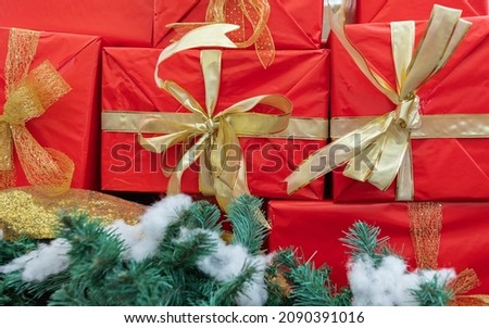 Christmas gift boxes with decorations. Red boxes with gifts tied golden color bows. Concept photo Christmas and Happy New Year. Selective focus, nobody