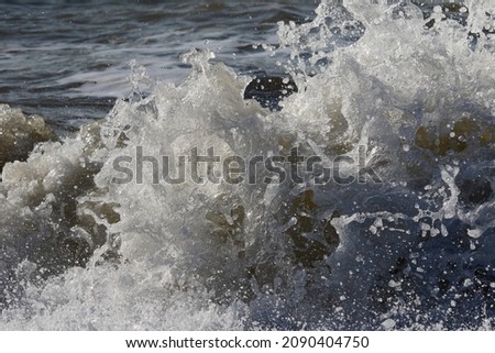 Splashes and foam among the waves near the Black Sea coast during a storm near the city of Evpatoria (Crimea, Crimean peninsula)