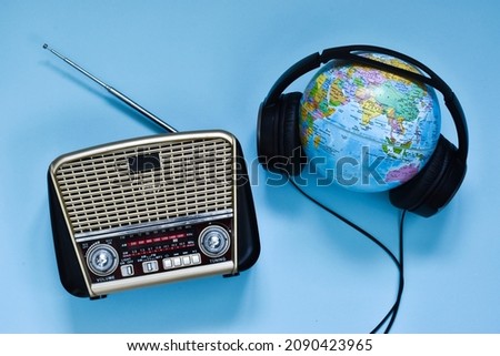 Retro radio, headphones and globe on blue background. World radio day. world music day. Top view, flat lay, top view Royalty-Free Stock Photo #2090423965