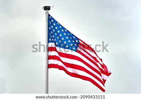 The USA flag is hanging on the flagpole