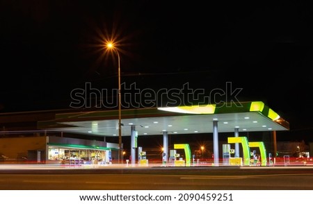 Gas station with motion traffic in city at night. Long exposure of car light, Czech republic