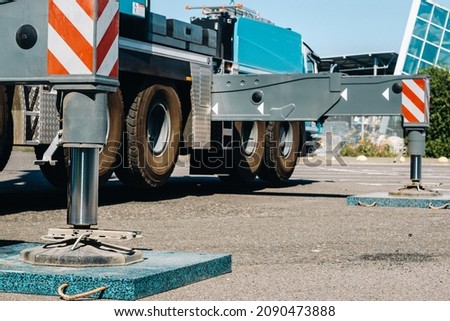 installed hydraulic support of an automobile crane. Royalty-Free Stock Photo #2090473888