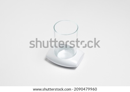 Glass with cup holder isolated on white background.High resolution photo.Top view. Mock-up.