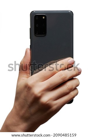 Smartphone in hand back view with camera isolated on studio background