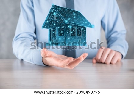 Man hold low polygon.Real estate concept, businessman holding a house icon.House on Hand.Property insurance and security concept. Protecting gesture of man and symbol of house.