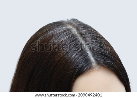 Gray hair on the crown of a Caucasian woman close-up. Royalty-Free Stock Photo #2090492401