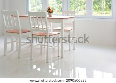 white room, glossy tiled floor with wooden table and chair set.  Royalty-Free Stock Photo #2090500528