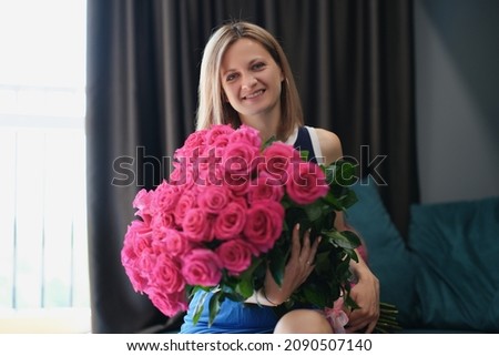 Beautiful young woman get bouquet of flowers on birthday or anniversary Royalty-Free Stock Photo #2090507140