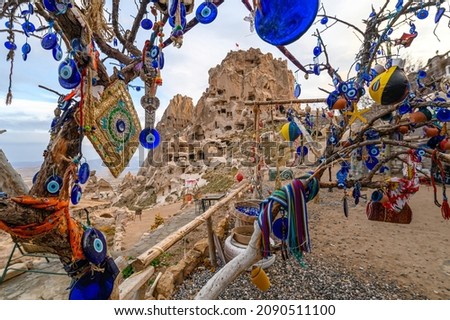 Uchisar Castle, town in Cappadocia, Turkey near Goreme. Cappadocia landscape and valley with ancient rock formation and caves. Royalty-Free Stock Photo #2090511100