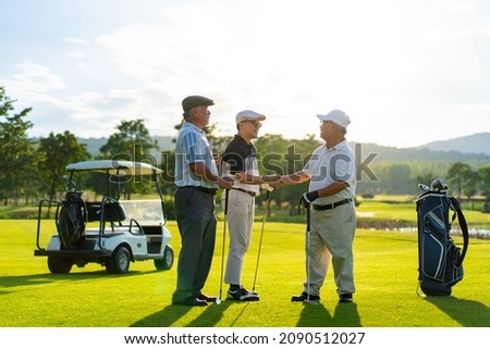Group of Asian people businessman and senior CEO shaking hand after finish talking business project and game on golf course. Male golfer enjoy outdoor sport lifestyle golfing together at country club.
