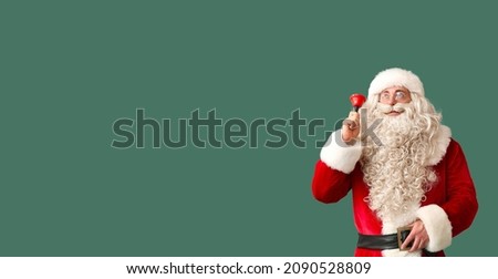 Santa Claus with Christmas bell on green background with space for text