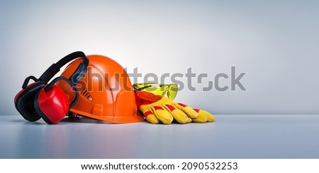 Work safety protection equipment on grey background with copy space. Horizontal banner. Royalty-Free Stock Photo #2090532253