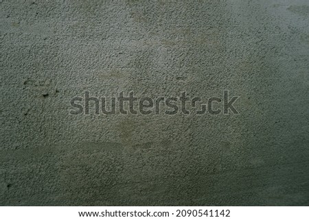 Surface of fresh cement plaster. Texture of gray wet plaster on the wall.