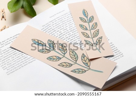 Book with bookmarks on light background, closeup