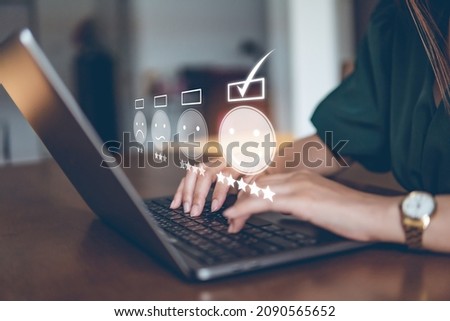 Customer Experience Concept, happy Business women holding the smartphone with a checked box on Excellent Smiley Face and Rating for a satisfaction survey,  and positive customer feedback testimonial. Royalty-Free Stock Photo #2090565652
