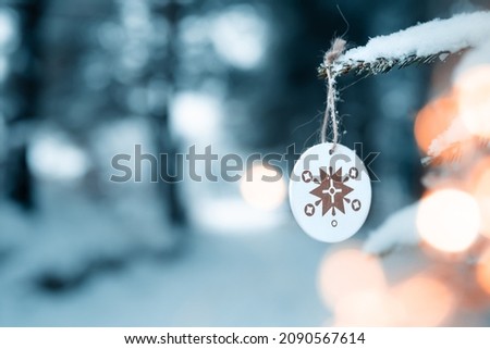  Happy holidays, Merry Christmas, Cute christmas decoration on a coniferous tree covered with snow in the middle of the forest,christmas 2021