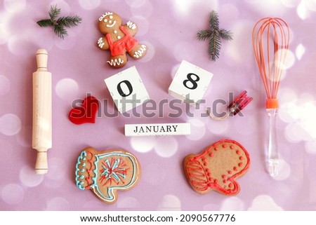 Calendar for January 8: name of the month in English, cubes with numbers 0 and 8, gingerbread men, mittens, fir branches, toy sledges, kitchen utensils, red heart on a pastel background, top view