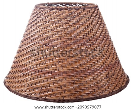 empire bell shaped woven basket brown straw lampshade on a white background isolated close up shot