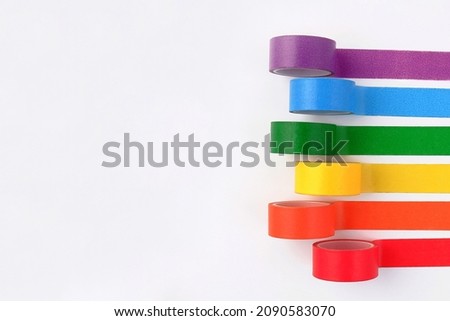 Multicolored rolls of rainbow-colored adhesive tape on the side on a white background.A set of bright sticky decorative ribbons for creativity, gift box packaging, for making postcards.Copyspace Royalty-Free Stock Photo #2090583070