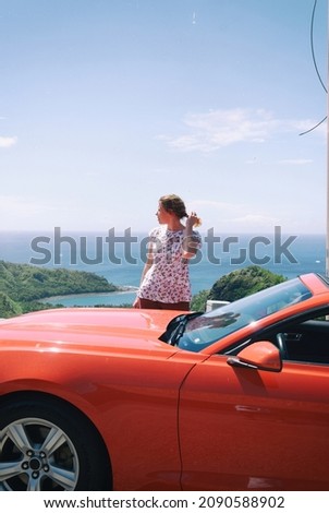 beautiful russian european girl red convertible car on the background of the tropical island guam