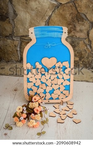 Composition for Valentine's, Mother's or Women's Day. Blue picture with wooden heart on old stone background. Still-life.
