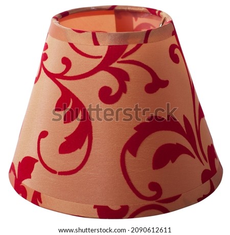 classic empire cone bell shaped orange tapered lampshade with red floral pattern on a white background isolated close up shot 