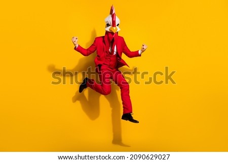 Photo of astonished office worker jump rejoice vacation wear chicken polygonal mask red tux isolated yellow color background Royalty-Free Stock Photo #2090629027