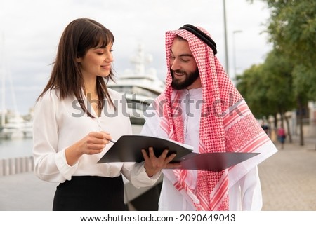 Friendly diverse man and woman reading contract