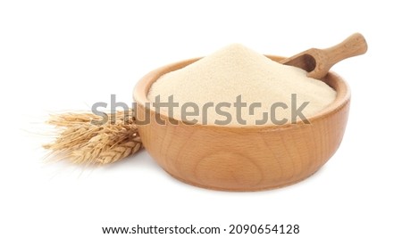 Semolina and scoop in wooden bowl on white background Royalty-Free Stock Photo #2090654128