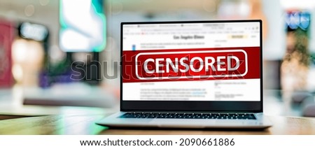 Laptop computer displaying the sign of censorship on an internet news site Royalty-Free Stock Photo #2090661886
