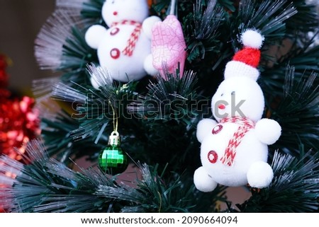 Teddy bear on the pine tree and stars for Christmas.