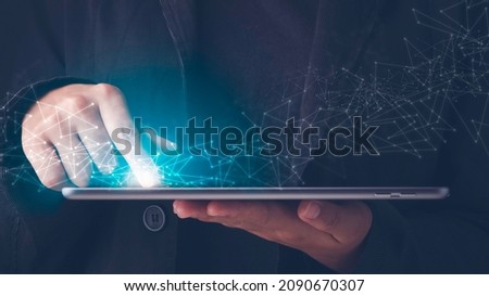 Wireless communication, High speed internet, Connecting network around the world with technology concept. Finger touches tablet screen and blue light with a virtual digital connection line.