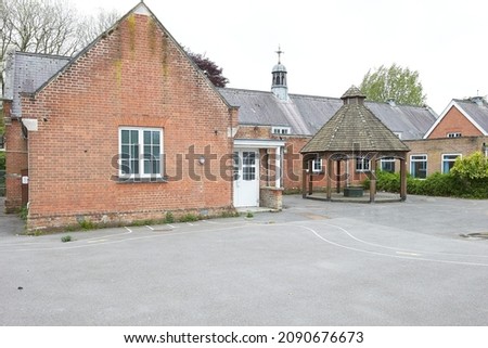 School playground no longer in use, becoming overgrown with weeds Royalty-Free Stock Photo #2090676673