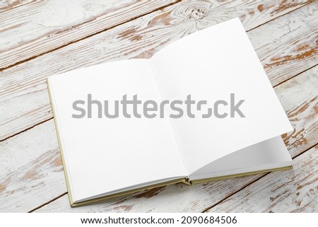 Blank open book on wooden background