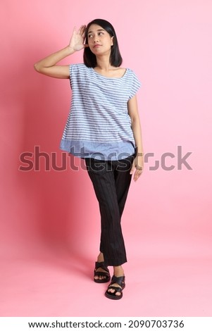 The Asian woman on the pink background.