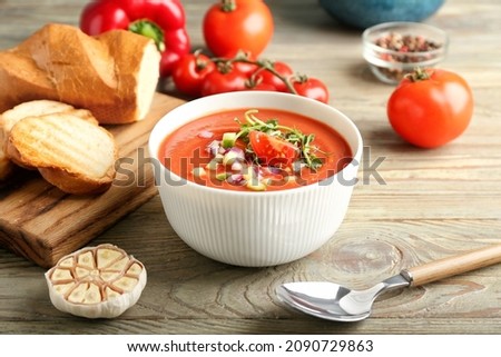 Bowl with tasty gazpacho on wooden background Royalty-Free Stock Photo #2090729863