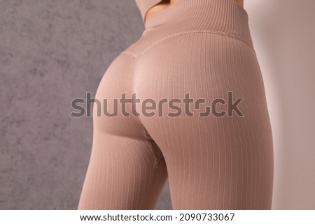 Close up of buttocks fitness woman in sportswear. Home fitness workout. Female athletic glutes and legs close up. Royalty-Free Stock Photo #2090733067