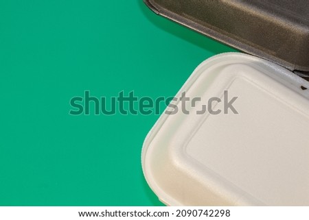 Containers for carrying food on a green background. Restaurant delivery service