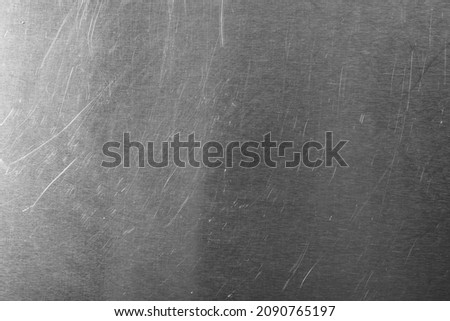 Old metal surface with scratches as background, closeup