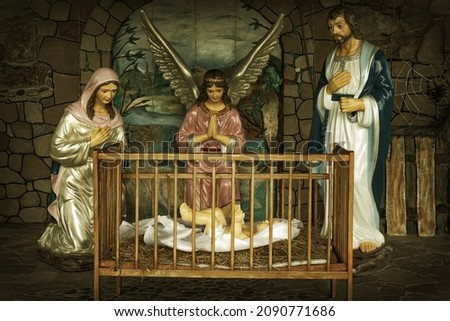 Christmas nativity scene. Jesus in the crib. Mary, Joseph and the angel beside him. This image was taken on public property.