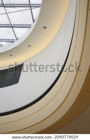 Ceiling and glass roof of an office building. Abstract modern architecture and interior. Construction industry background in hi-tech style with curves and framed windows. Round structure of surfaces.