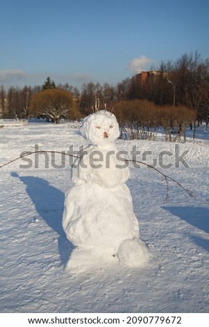 Snowman on a winter sunny day.
