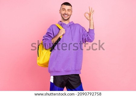 Photo of young cheerful guy show okey symbol great choose recommend isolated over pink color background