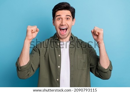 Photo of shocked ecstatic guy win luck lottery raise hands up shout yea isolated on blue color background Royalty-Free Stock Photo #2090793115