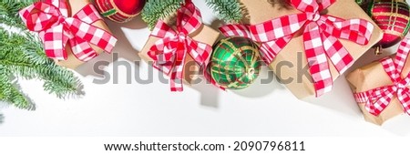 Christmas background with hand crafted gift boxes, fir tree branches and Christmas tree ball, white background copy space