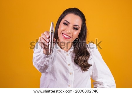 Nurse and beautician holding a dermapen for lip hydration on yellow background.