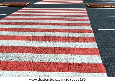 White and red crosswalk on the city road. Roads infrastructure and transport