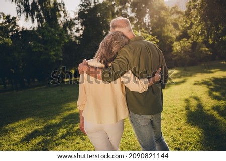 Back rear side spine view photo of old people grey haired man woman embrace harmony look nature outdoors outside in park Royalty-Free Stock Photo #2090821144